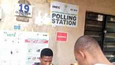 This is polling Station aEC 30A, people are on queue voting , No 19 ,Olashinde Street Mushin.