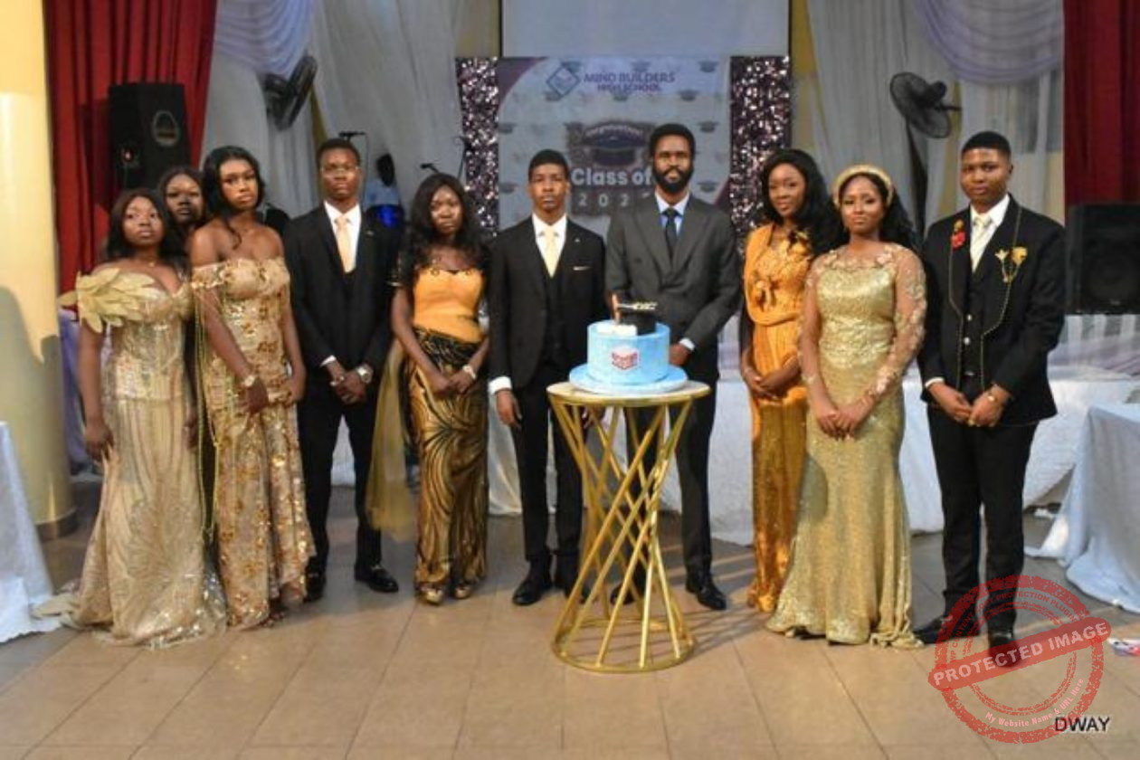 An old student-turned lawyer(middle), with some graduating and the graduation cake
